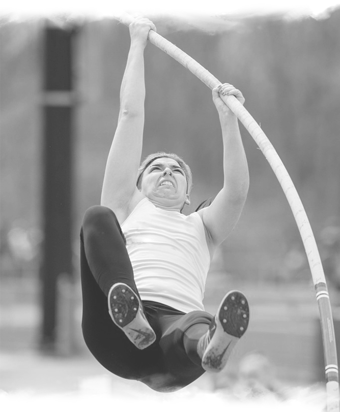 a woman is jumping in the air on a high jump