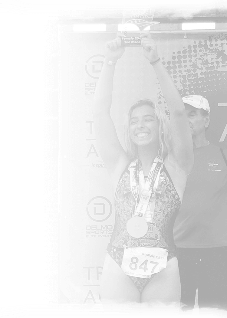 a black and white photo of a woman holding up a trophy